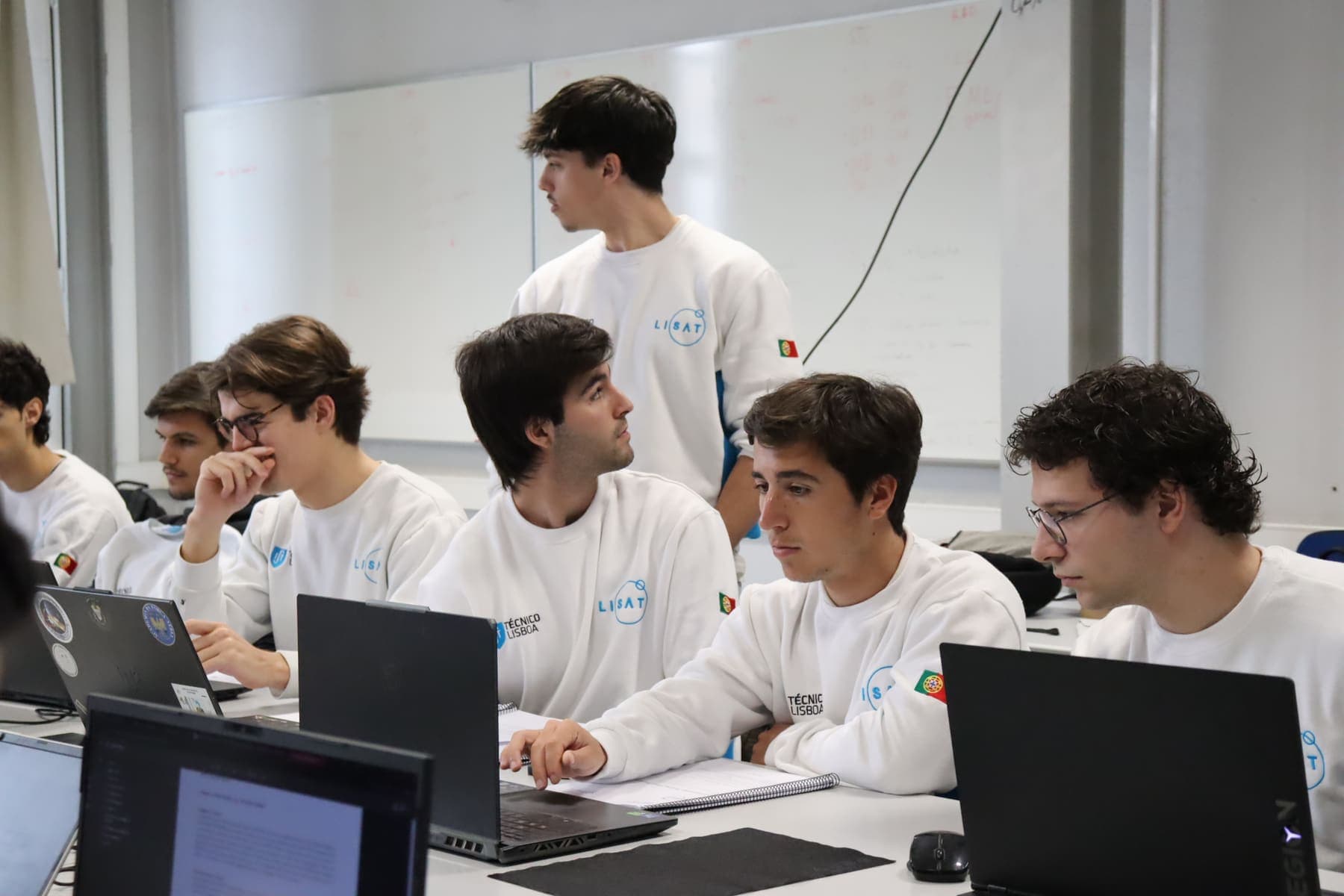 Team members at their laptops during the Critical Design Review